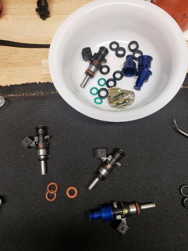 Injector set with adapters removed for new O-rings and grommets during cleaning service.