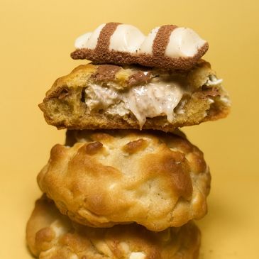 Stack of creamy-filled cookies with a textured golden-brown crust.
