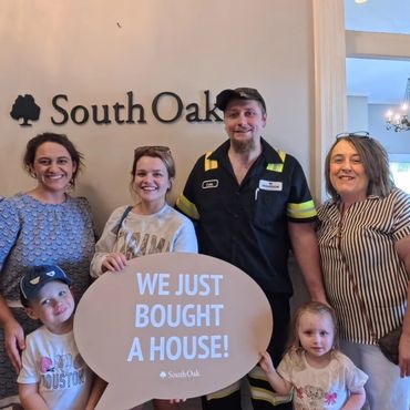 Happy family celebrating buying a new house with South Oak.
