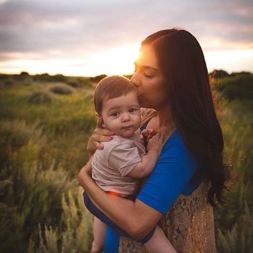 mom kissing baby