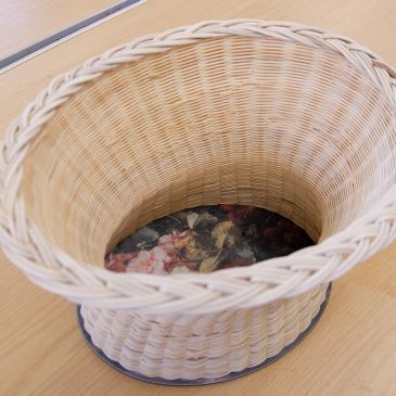 Empty woven basket on wooden surface.
