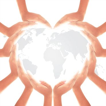 Hands forming a heart shape over a world map, symbolizing global care and unity.