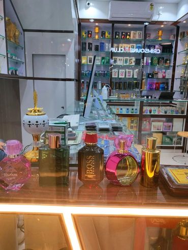 Perfume bottles displayed at a cosmetics store counter.