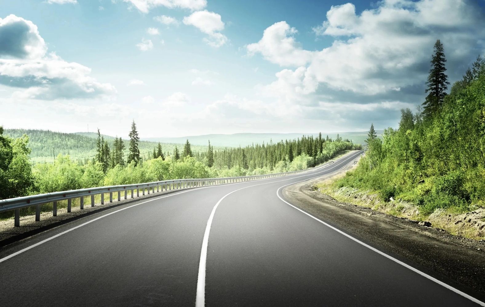 A Winding Road with Clear Skies Overlooking a Cliff.