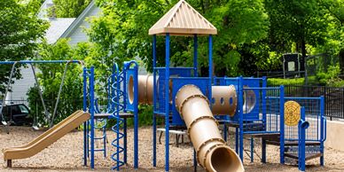 Blue and tan children's playground set outdoors.