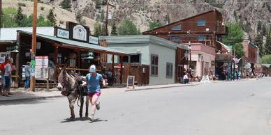 pack burro racing team at finish line in creede co