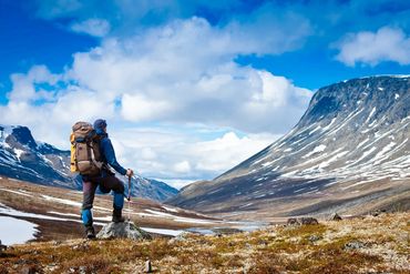 Backpacker in remote mountain valley