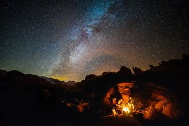 Night sky with stars and campfire