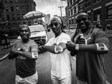 Three musicians from Haitian band Rara Bel Poze posing for a picture