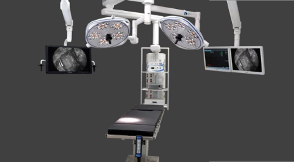 Modern operating room setup with surgical lights and monitors.