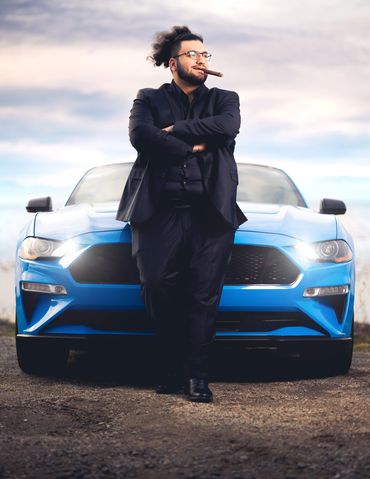 A luxurious photograph of a gentleman with his sports car.