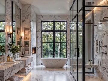 Sleek master bathroom with marble walls and freestanding tub.