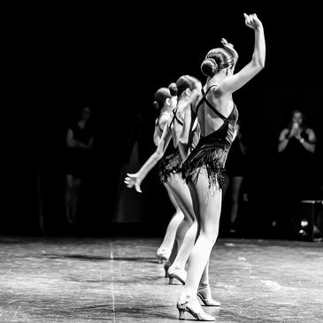 Jazz dancers performing on stage in a live performance.