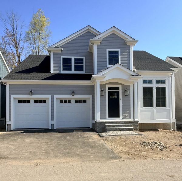 Modern two-story house with gray siding and a double garage.