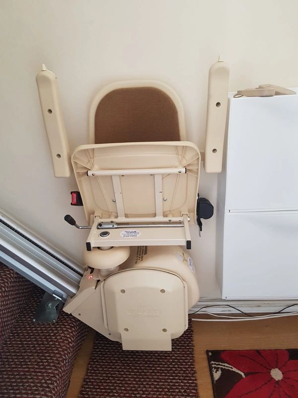 Stairlift - Neatly folded back to enable other occupants to utilise stairwell easily