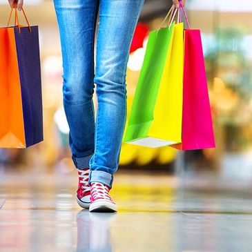 Person with shopping bags depicting increased sales.  ATM907 has best ATM service in Wasilla, Alaska.