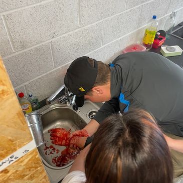 Man injured at work receiving first aid