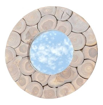 Round mirror with wooden log frame reflecting sky.