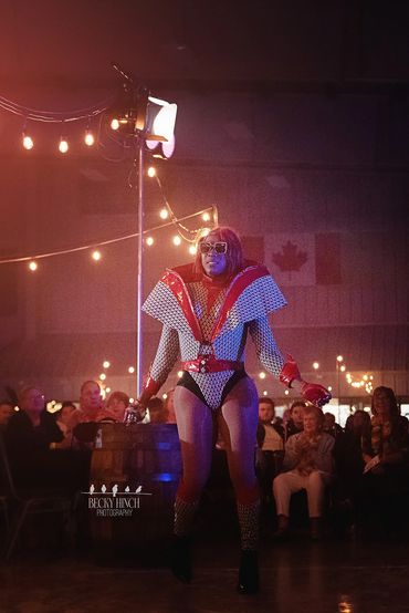 Portrait of drag artist laughing offstage, candid moment showing joy and authenticity.