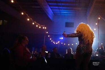 Conceptual fine art portrait of drag performer blending masculine and feminine elements in soft ligh