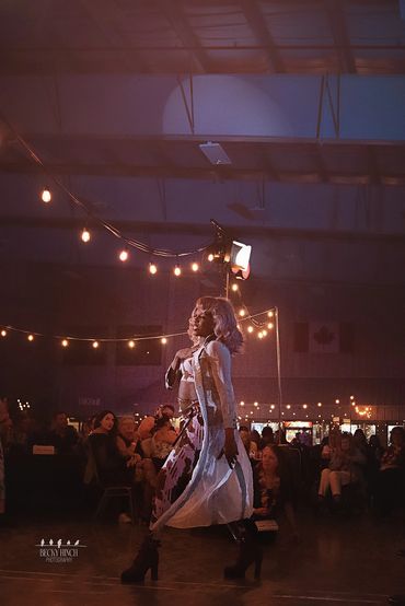 Expressive drag performer lip-syncing on stage, captured in dynamic fine art photography style.