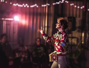 Inclusive portrait of drag performer surrounded by supportive friends, community photography project