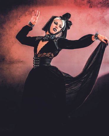 Vibrant portrait of drag performer mid-pose, celebrating self-expression and artistry.