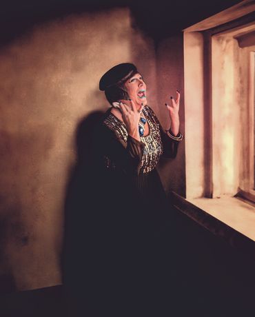 portrait highlighting detailed drag makeup and emotion through the eyes, fine art storytelling style