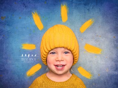 Whimsical portrait of a smiling toddler radiating sunshine and warmth