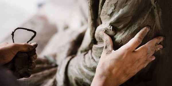 person in the process of sculpting