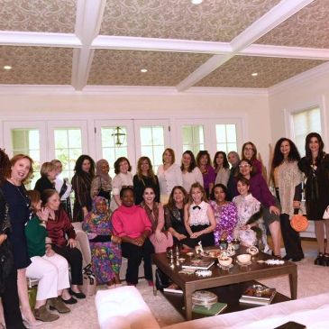 Group of women gathered in a living room for a social event.