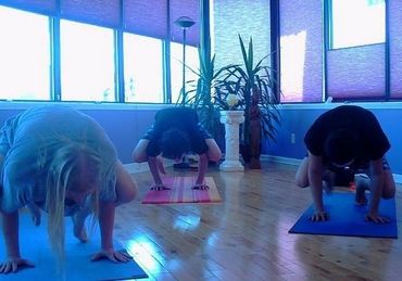 Three people doing yoga