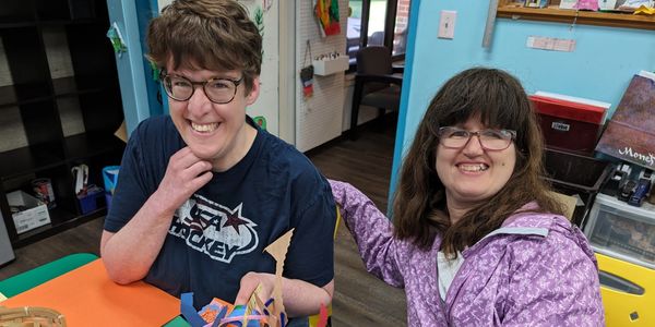 two cheerful ladies smiling for the camera in the studio OTB classroom