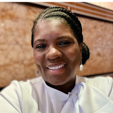 Woman with braided hair smiling.