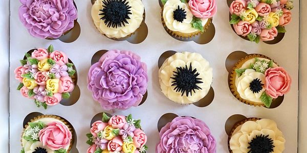 Lavender and anemone floral cupcakes boxed