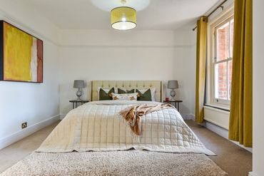 Master Bedroom with large sash window and custom walnut wardrobe