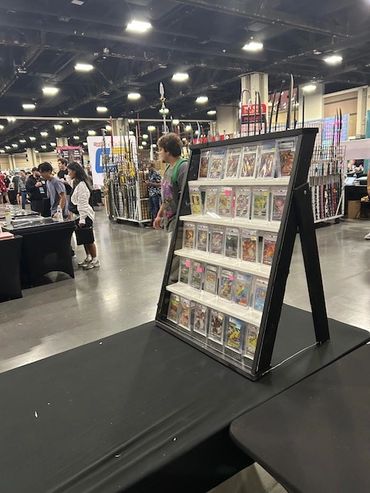 Display stand with graded comic books at a convention.