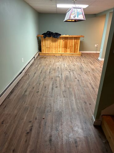 Empty room with wooden bar and ceiling lamp.