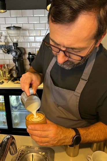 Barista pouring a cortado with latter art at Coffee Crowd, Newport Pagnell, Milton Keynes.