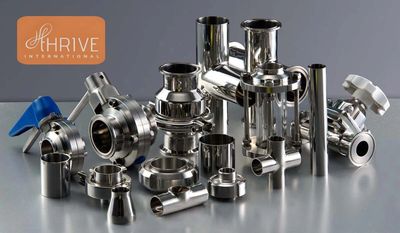 A collection of shiny stainless steel industrial pipe fittings and valves.