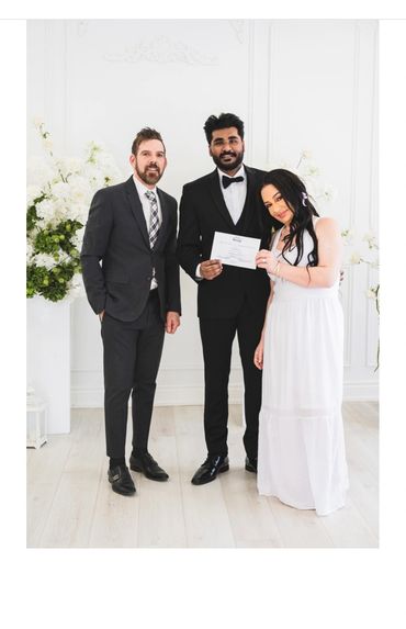 loving bride and groom with wedding officiant