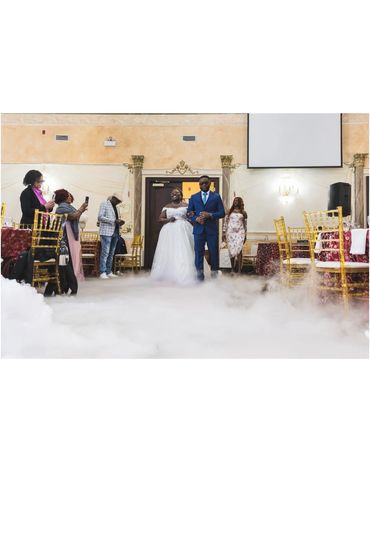 The bride and groom are entering the hall