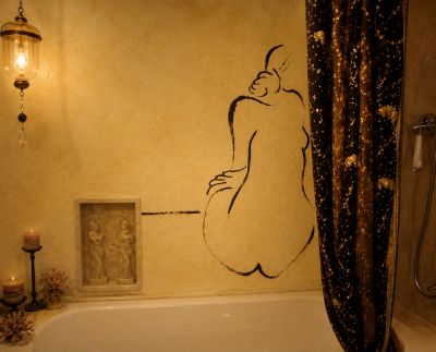 Artful bathroom wall with nude figure drawing.