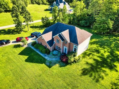 Aerial real estate photo of residential property surrounded by trees, photographed by ArKe Aerials.