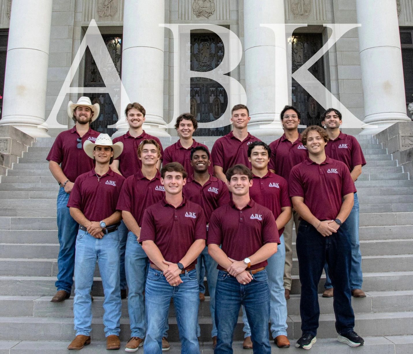 Aggie Business Kings officers smiling in front of Texas A&M Administration Building.