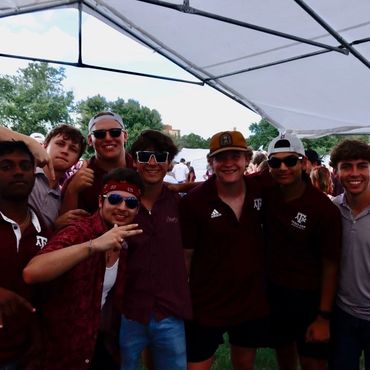 8 men wearing Texas A&M shirts.