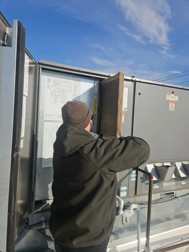 Maintenance technician working on a commercial unit.