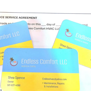 Three business cards sitting on top of service agreement form.