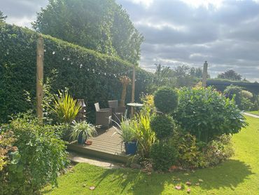 Maintained lawns and borders with ytimmed hedges