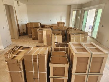 Room filled with numerous packed cardboard boxes ready for moving.